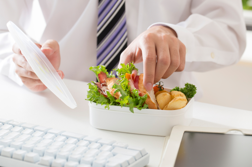 Image of an employee with a healthy lunch. Workplace wellness programs can help start healthy workplace habits.