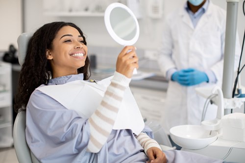 An employee covered by small business dental insurance at a routine cleaning.