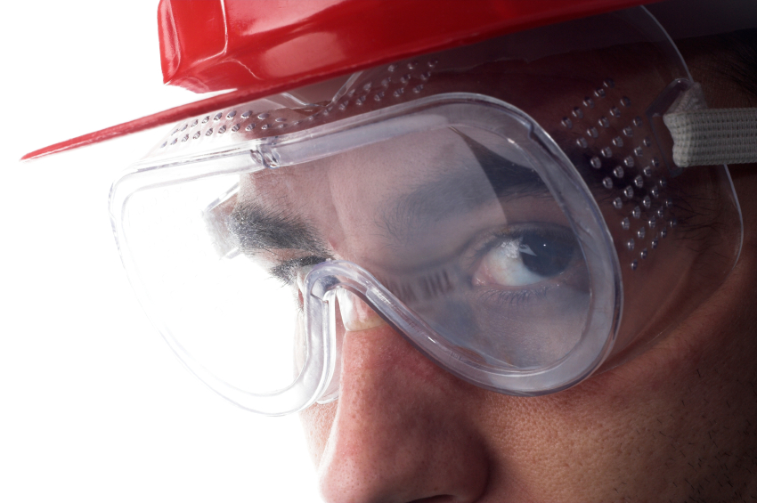 Image of an employee with safety goggles. GMS can help your company and its employees through risk management services.