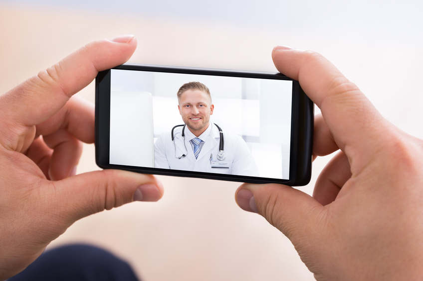 Image of a doctor during a telemedicine call. Telehealth services help your employees get medical help at all times.