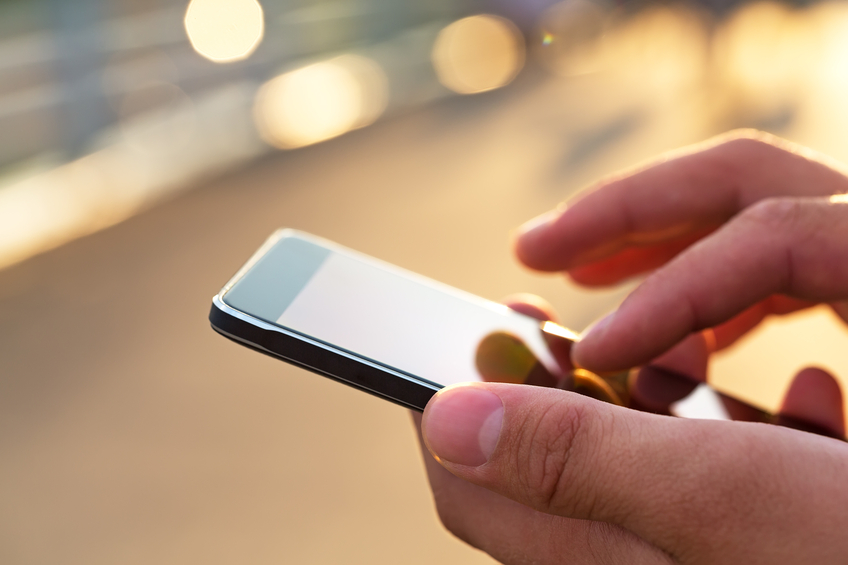 Image of a man using a PEO mobile app on his phone.