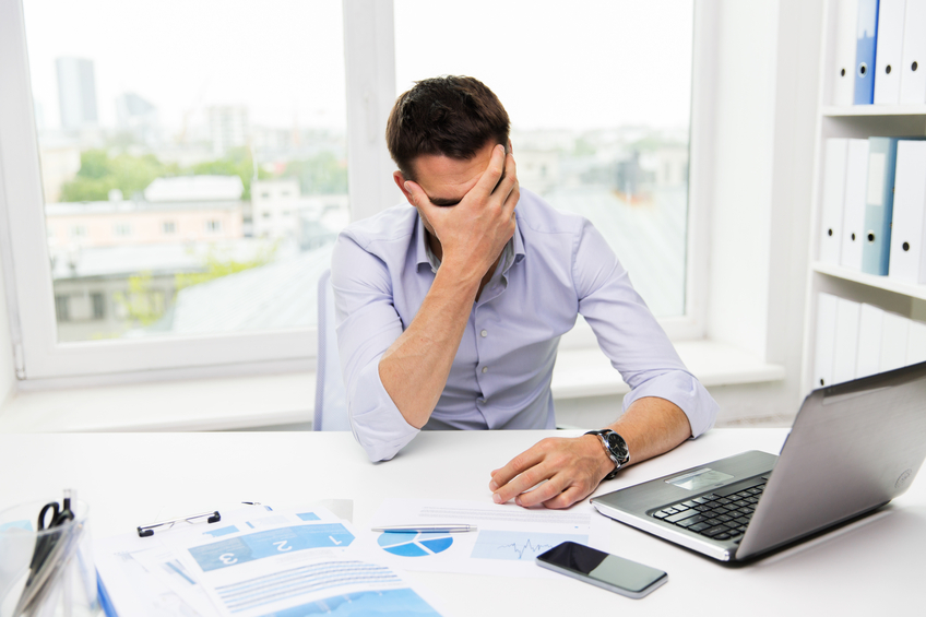 Image of a frustrated employee. Help releive stress with open PTO policies for your workplace.