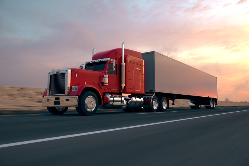 Image of a truck on the highway. Contact GMS about how a PEO can help transportation companies with HR functions.