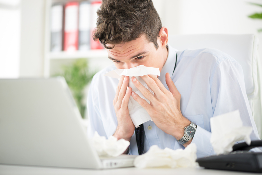 Image of a sick employee. Contact GMS about healtchare compliance for businesses.