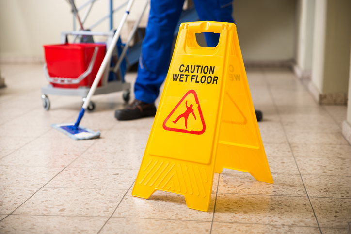 Image of a wet floor. Learn about the dangers of slip and fall accidents at work.