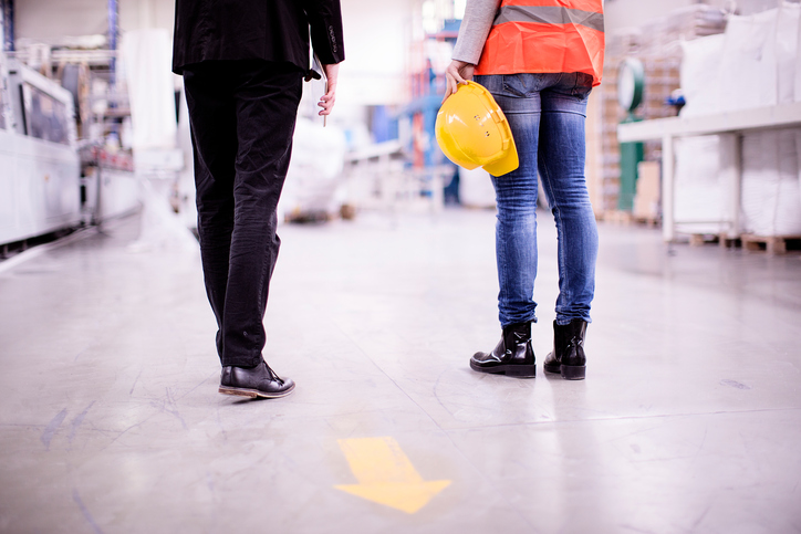 Image of a boss and an employee discussing workplace safety and risk management strategies.