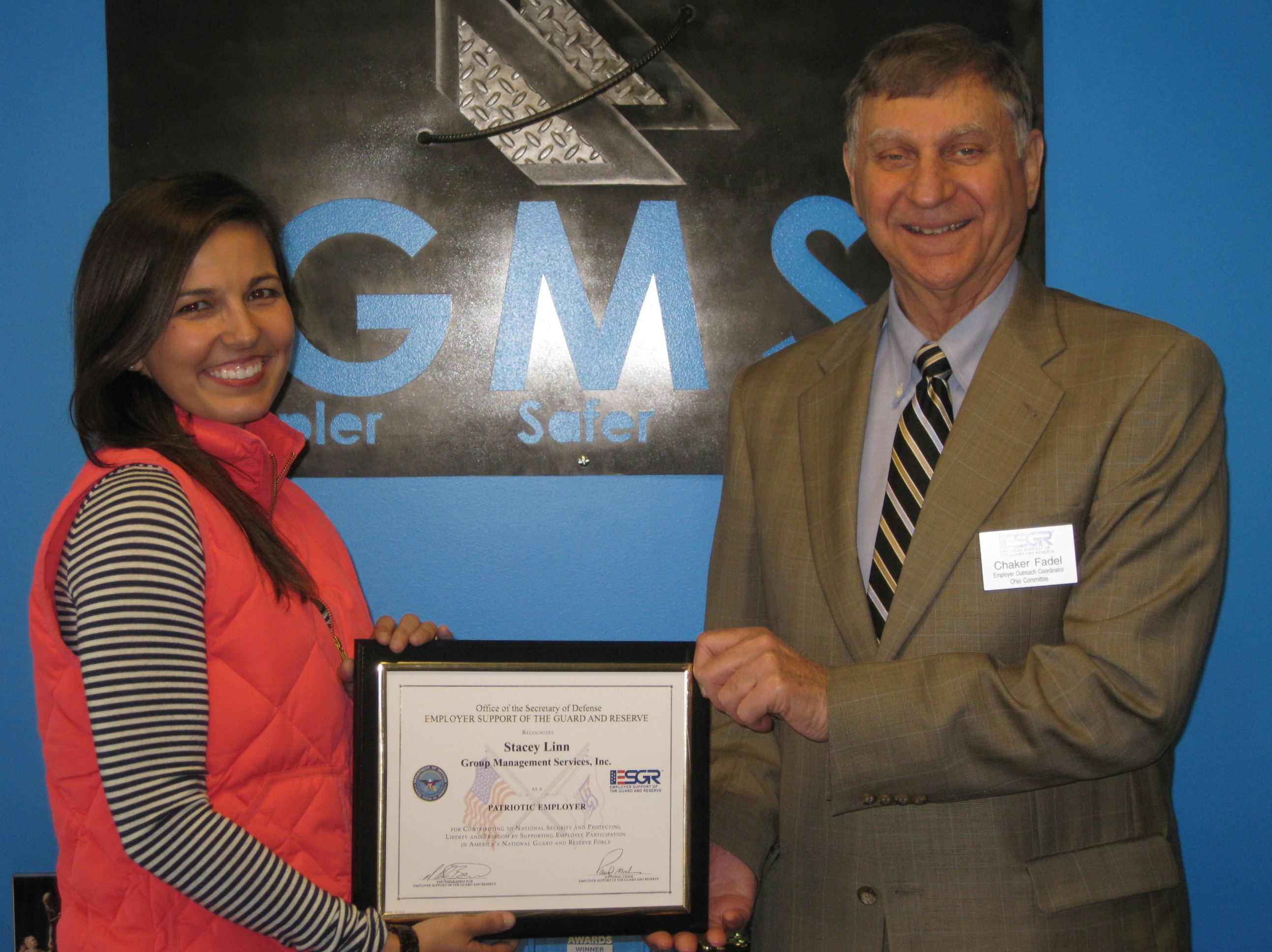 Image of Stacey Larotonda receiving her Patriotic Employer award from retired USAF Lieutenant, Colonel Chaker Fadel.