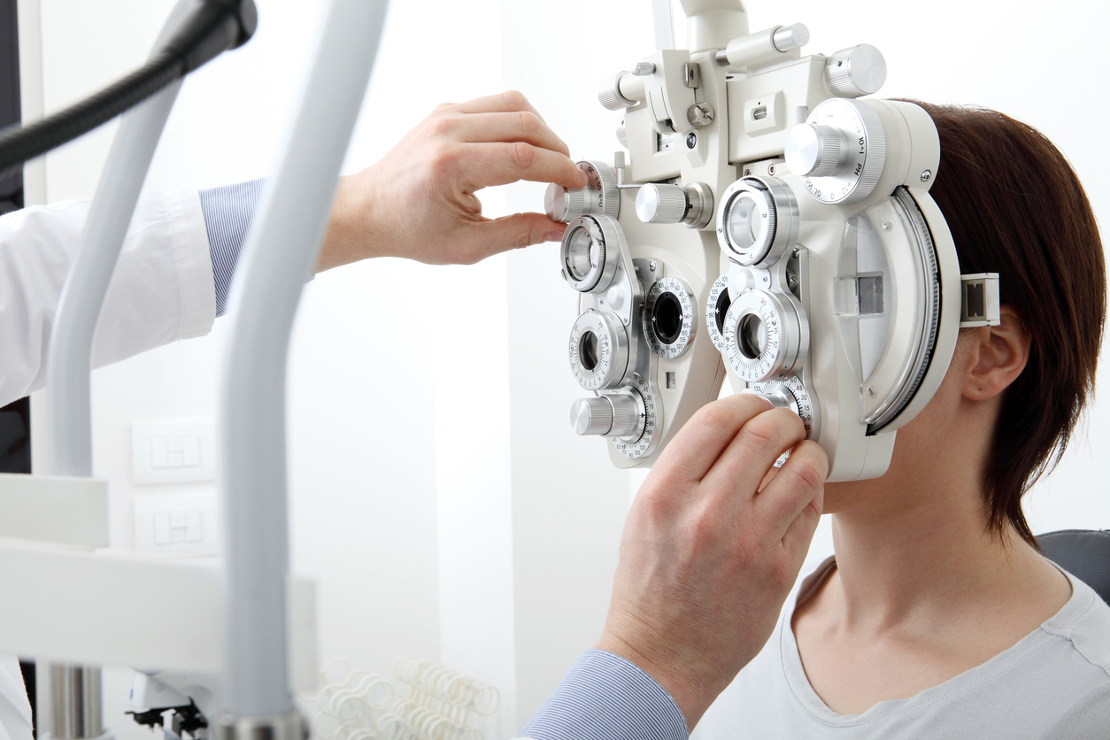 Image of a woman undergoing an eye test covered by a supplemental insurance plan.