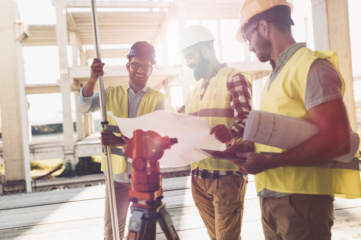 Constructions workers working in a safe worksite of a businesses investing in risk management services.