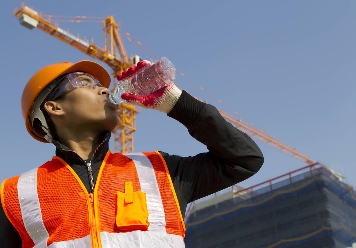 An employee practicing summer heat safety.