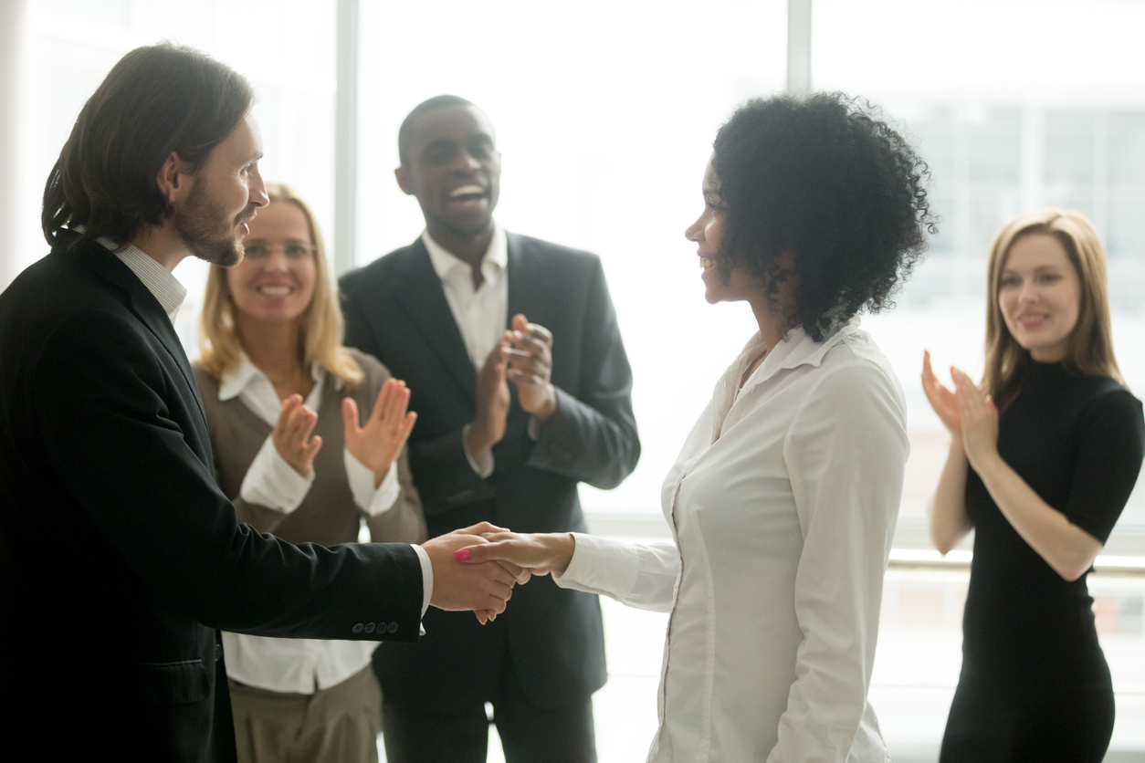 A small business owner recognizing an employee for hard work.