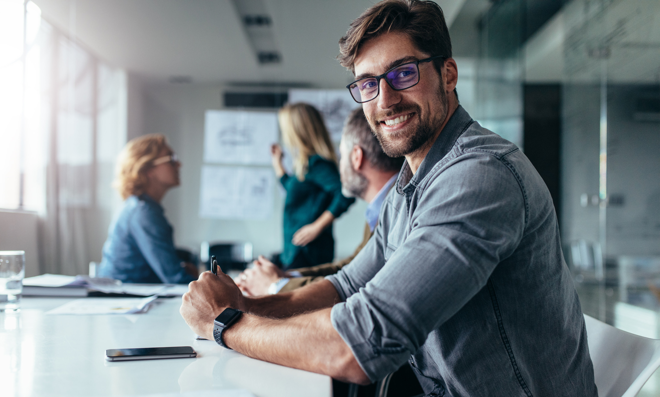 Young professional happily employed by a business that recruited millennials.