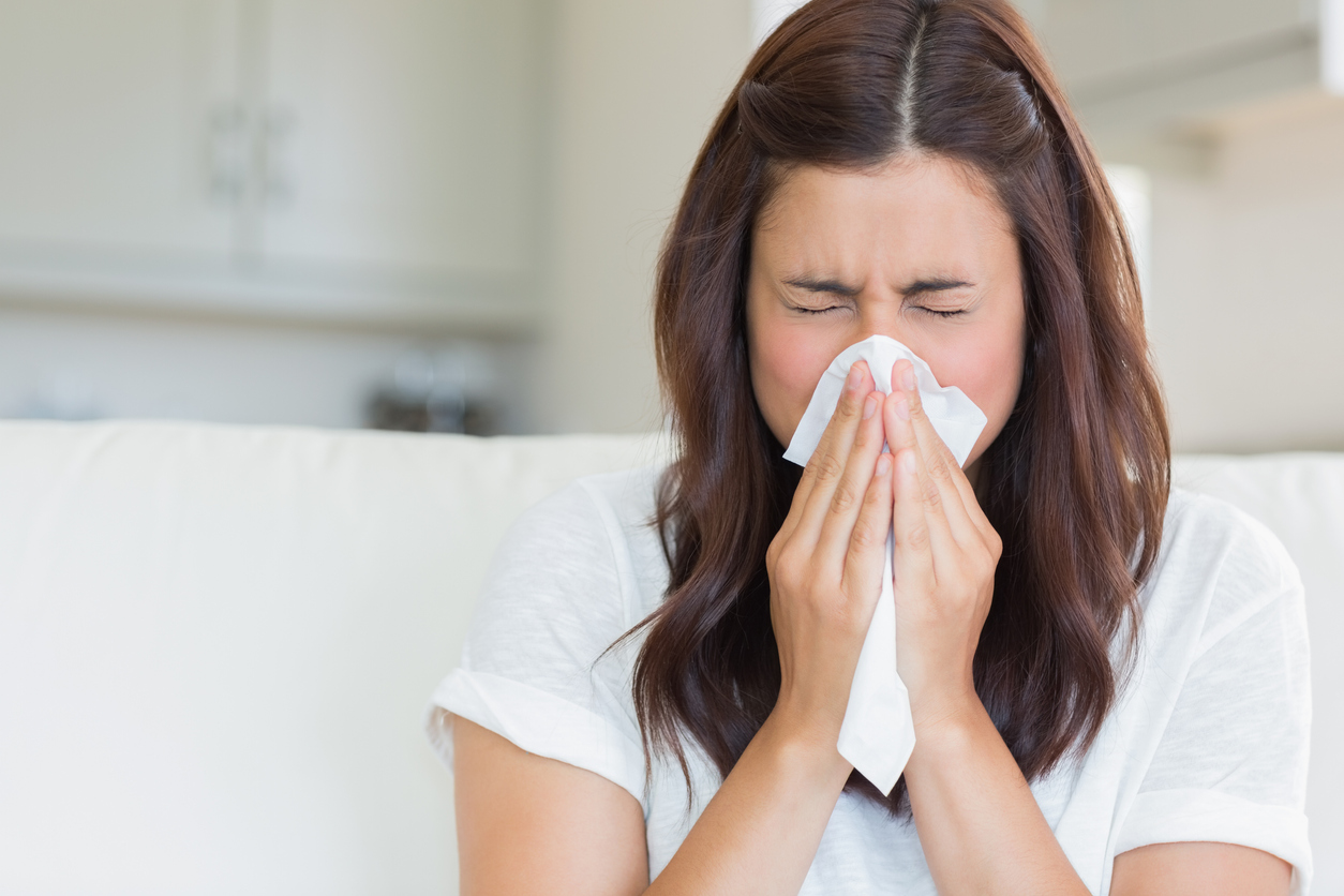 An employee staying home through her company’s paid sick leave policy.