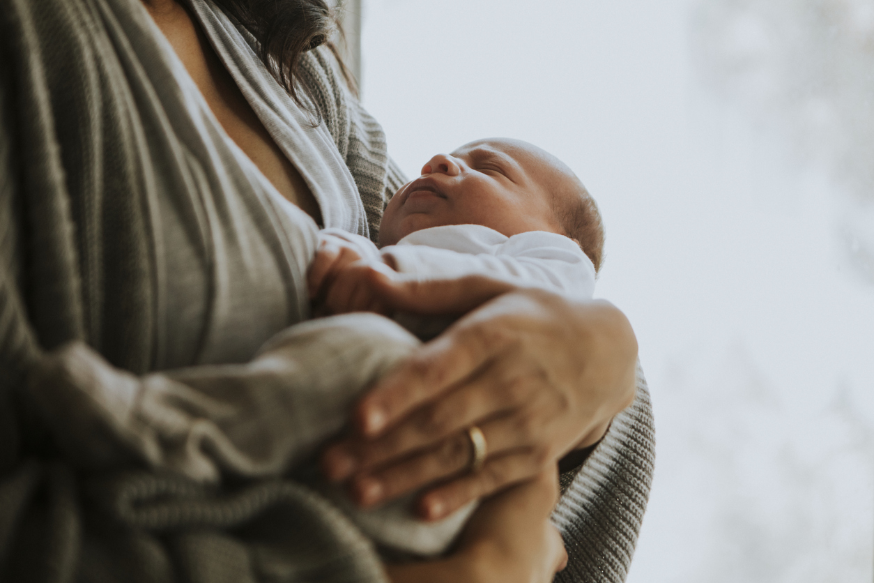 A mother taking family medical leave from work after the birth of her new child.