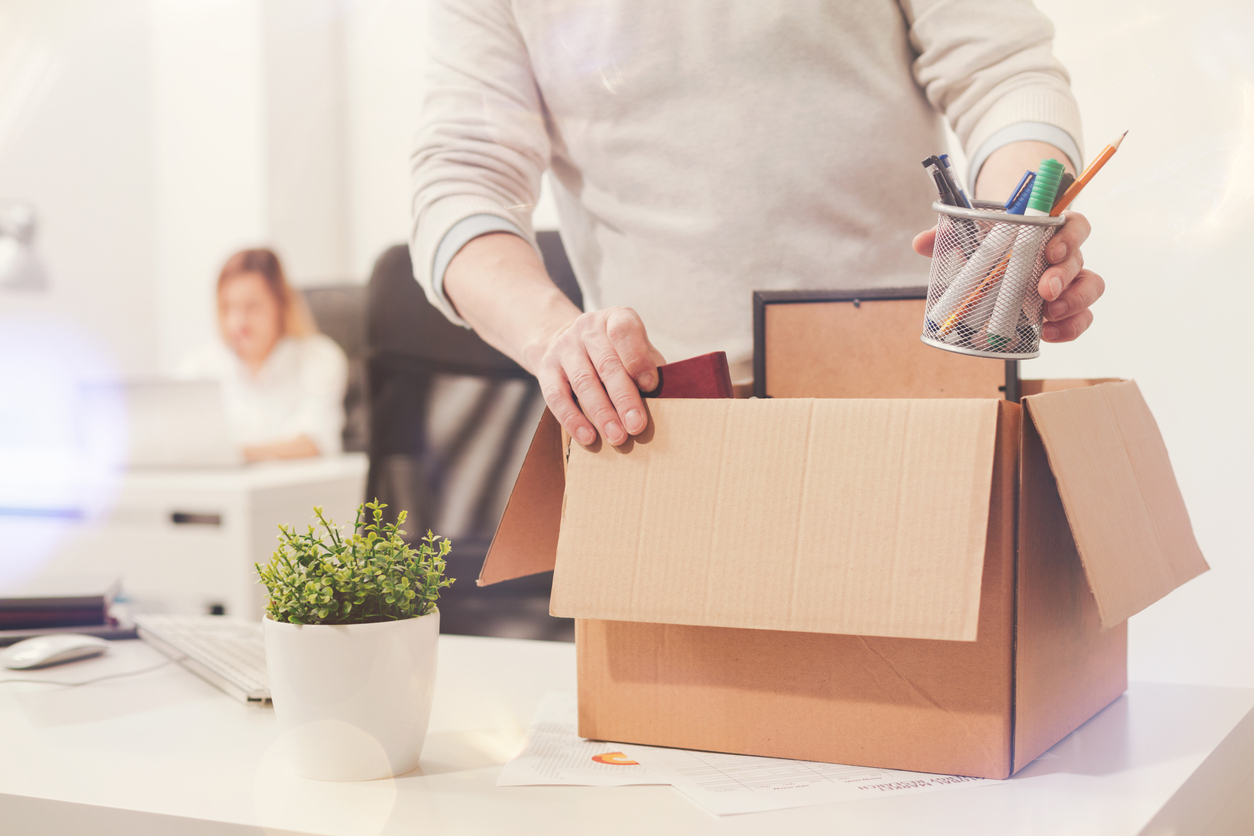 An employee gathering items after being fired by a small business owner.