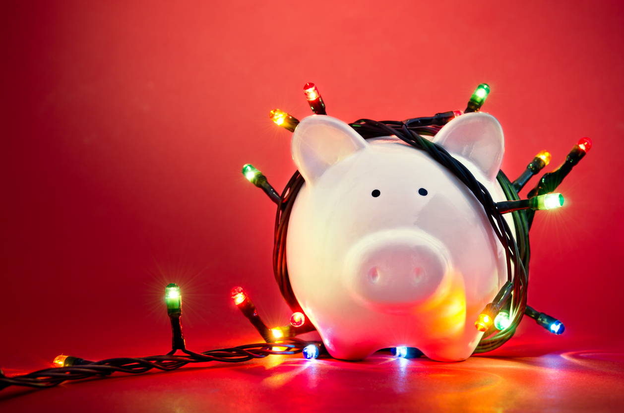 A piggy bank with Christmas lights representing holiday pay.