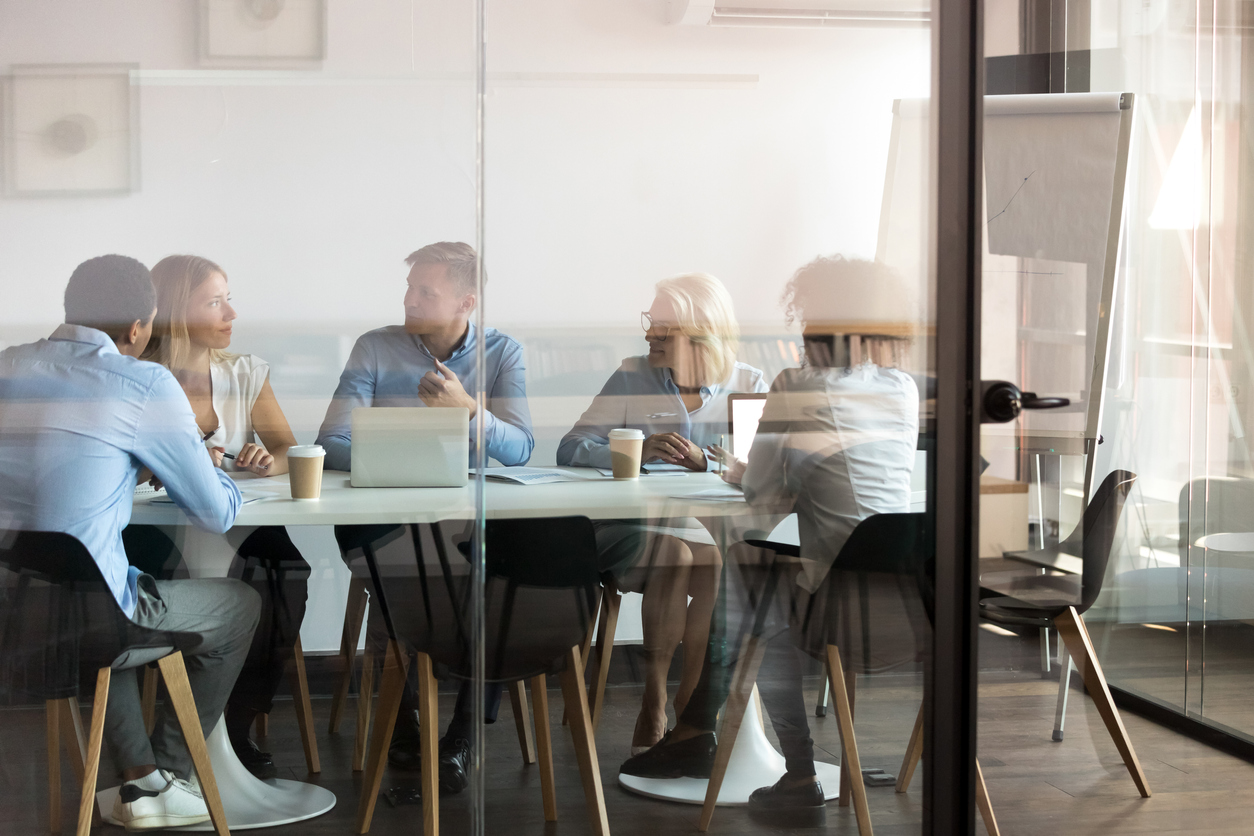 A group of interns and employees in a business setting.