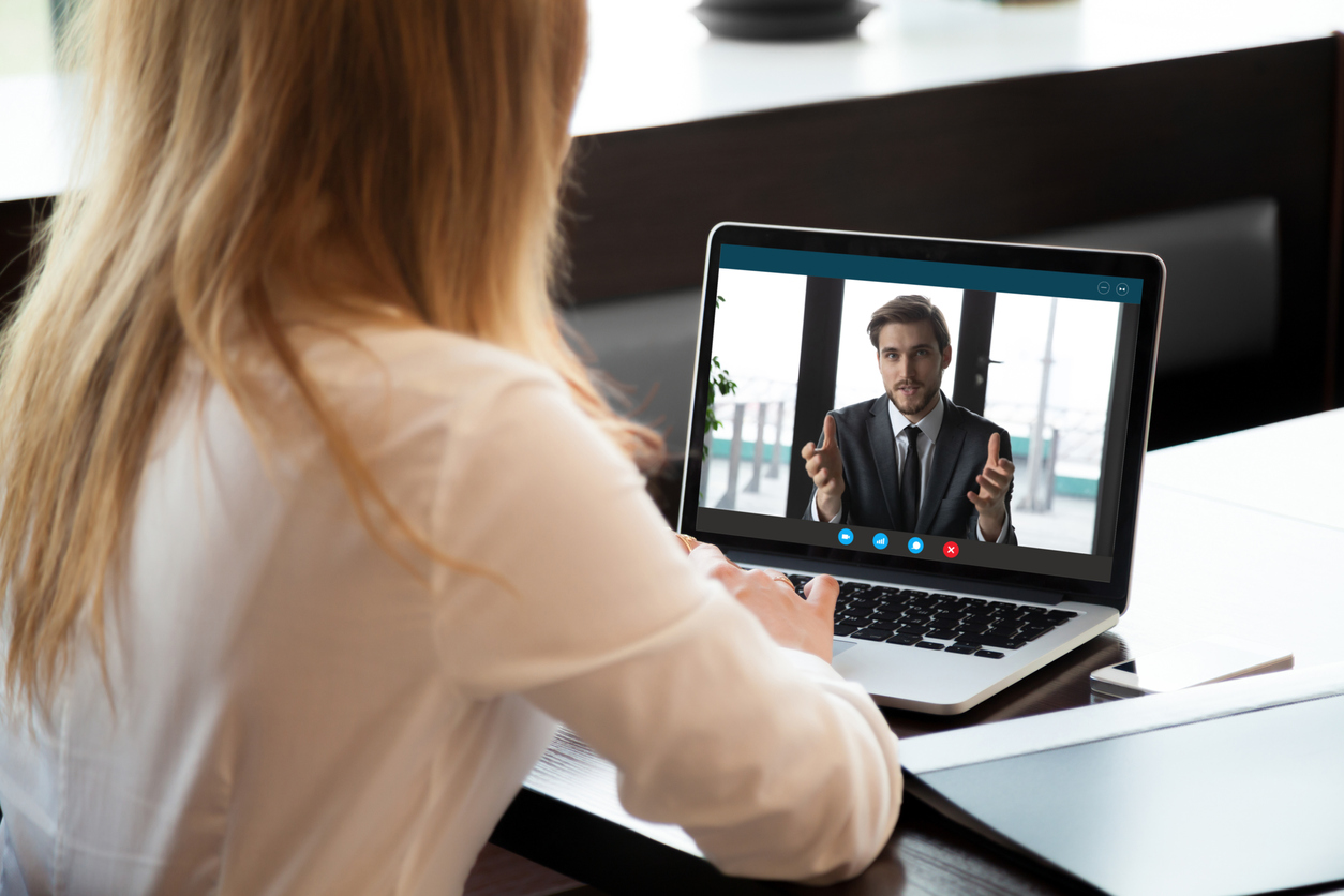 A remote emplyee using video conferencing technology to stay productive.