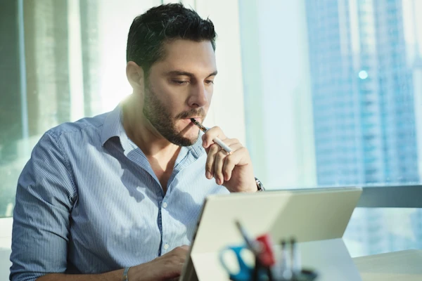 An employee vaping in the office before Florida’s ban on vaping in the workplace.
